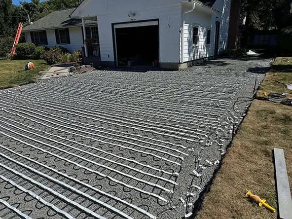 Large driveway with heated cable system installation laid out on concrete