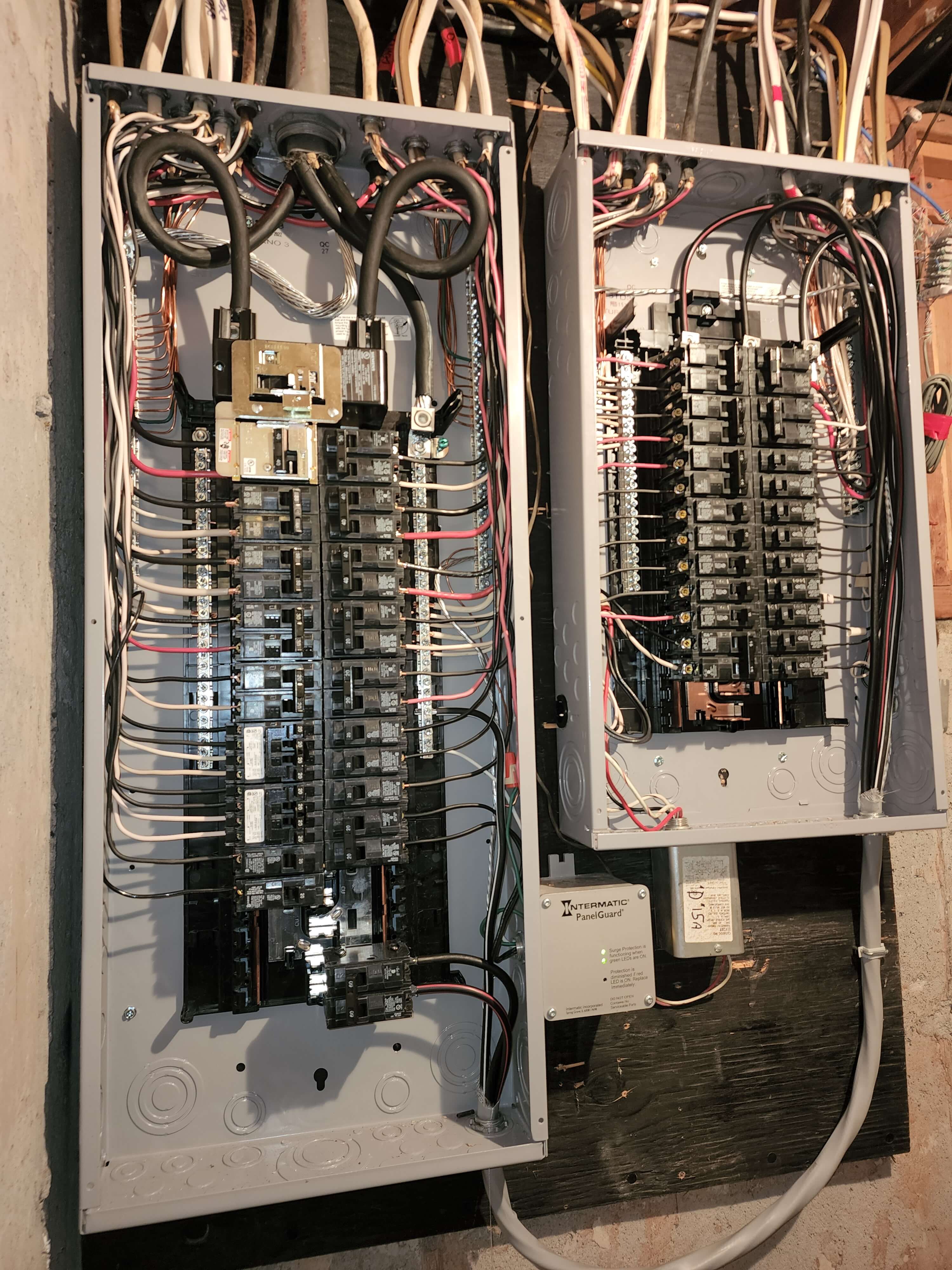Two electrical panels with Intermatic PanelGuard surge protector