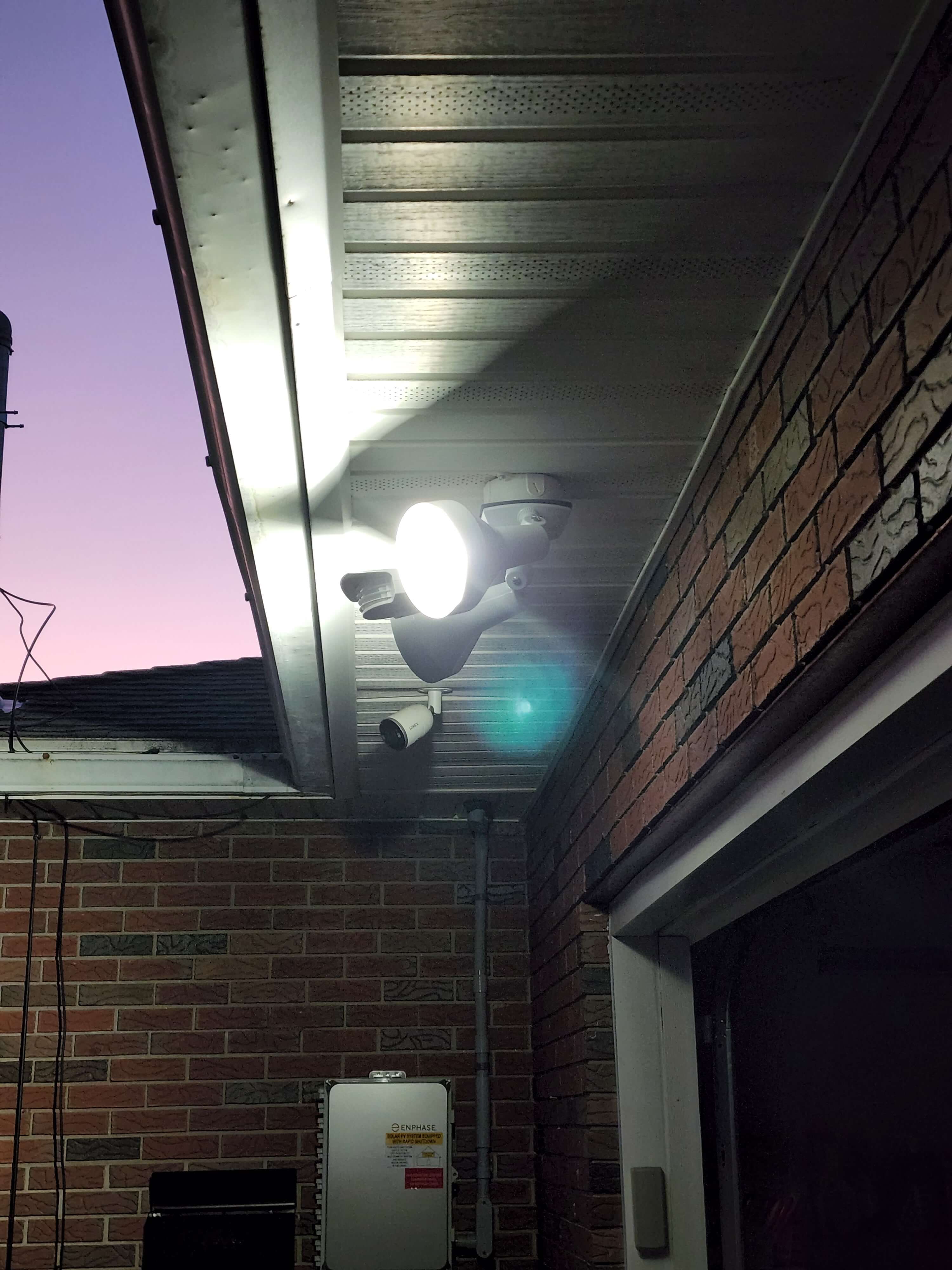 Outdoor security flood light with camera and Enphase inverter