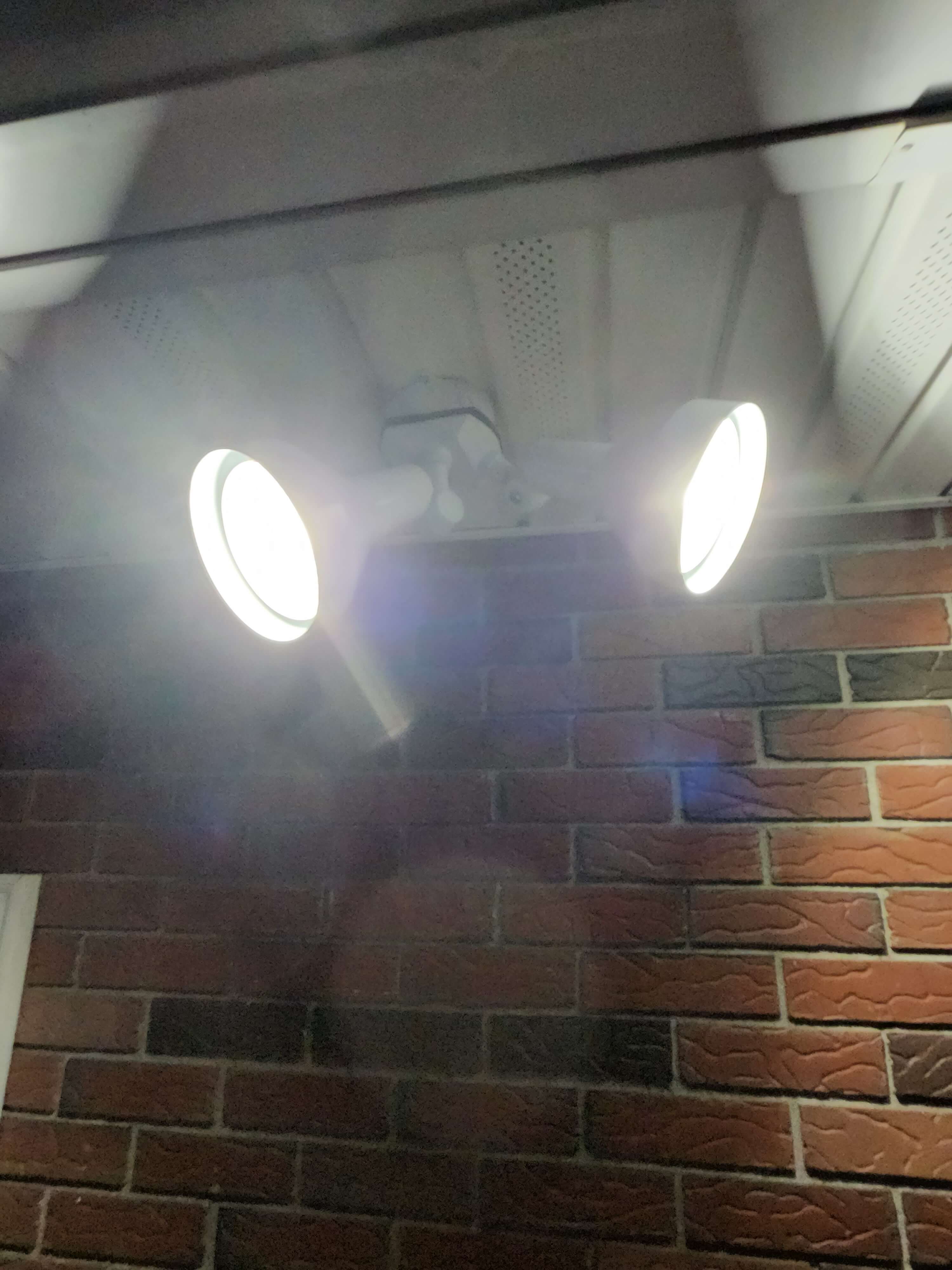 LED security flood light with motion sensor on soffit