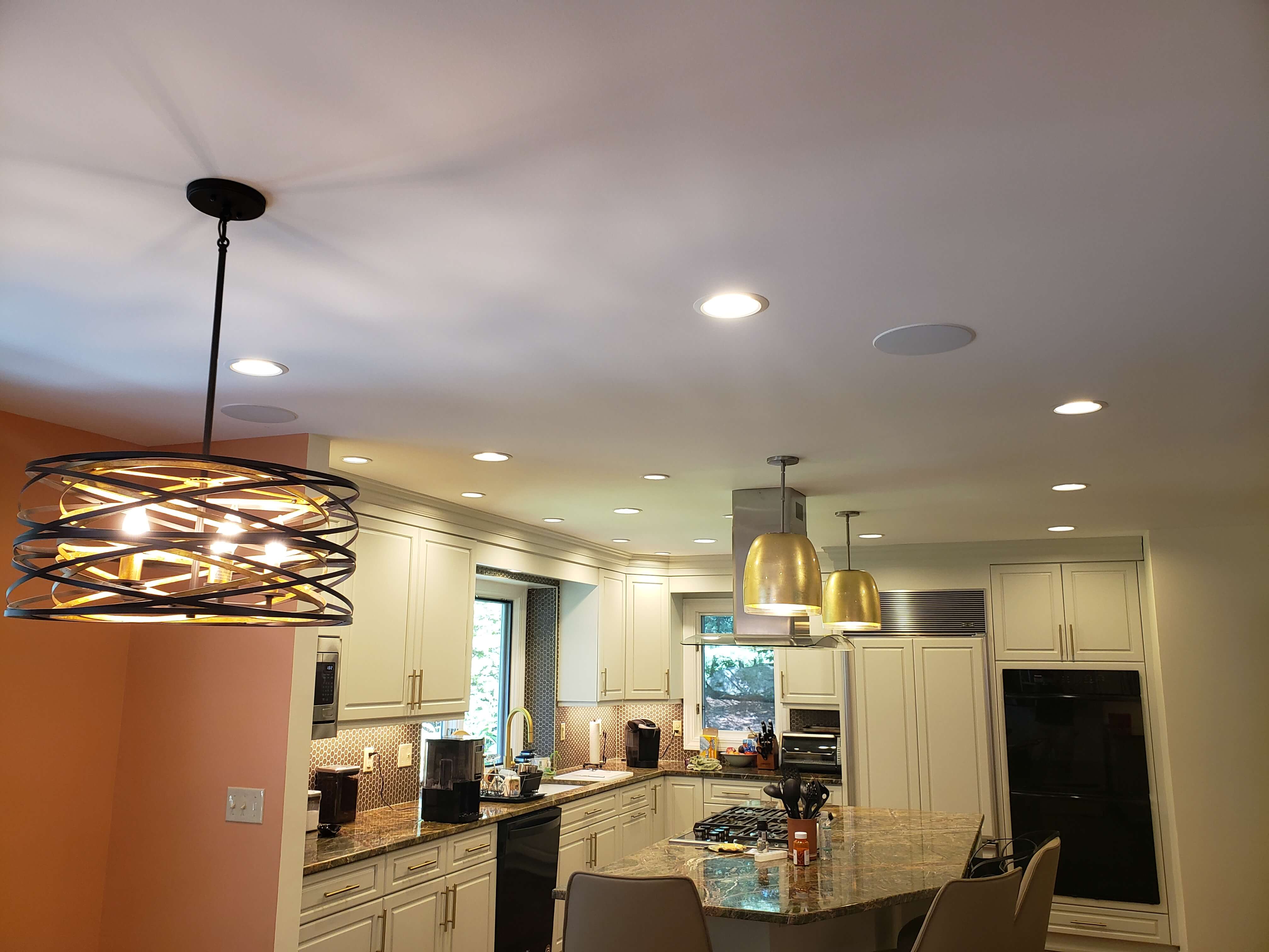 Modern kitchen with decorative pendant lights and recessed lighting throughout