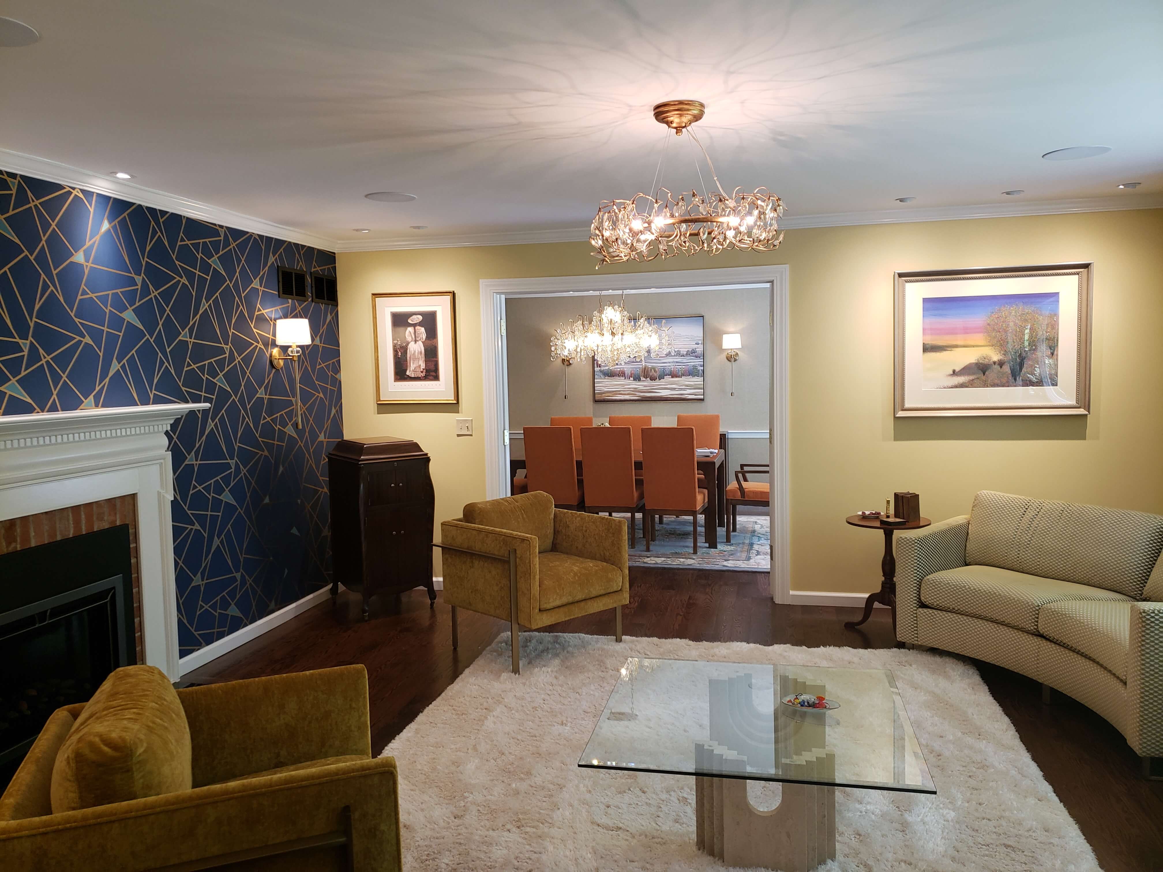 Elegant living room with decorative gold chandelier and blue accent wall