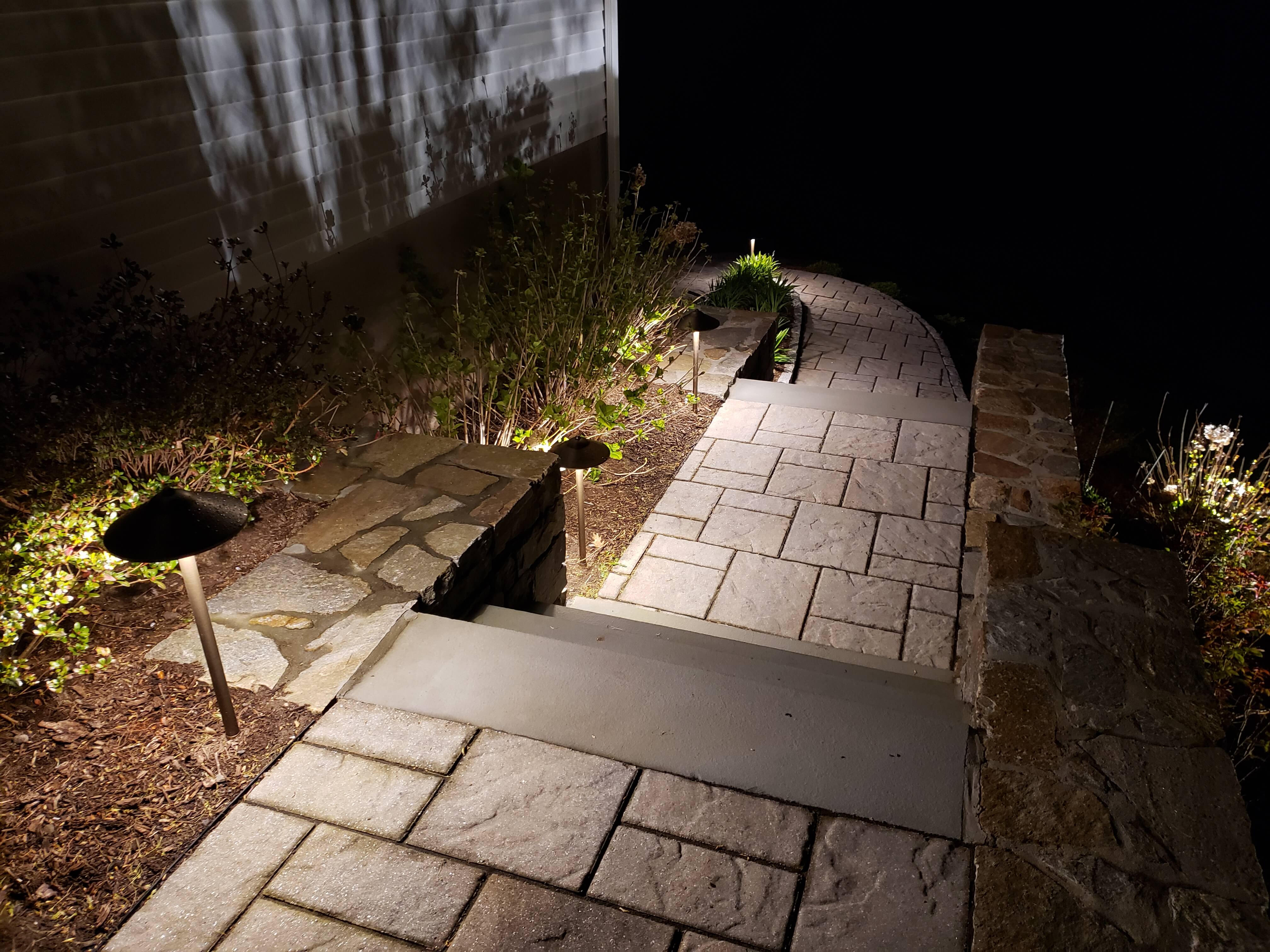 Stone pathway with mushroom lights leading to home steps