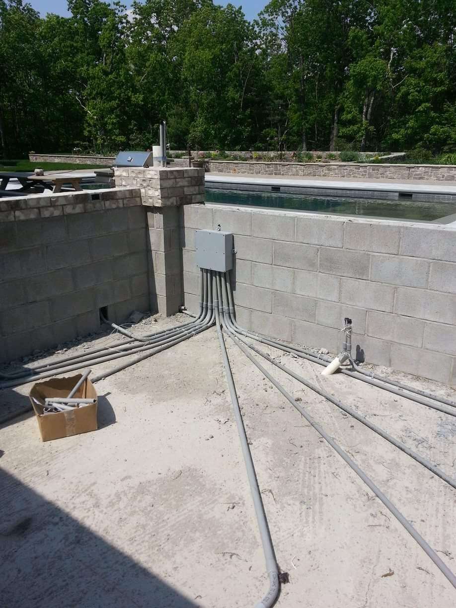Pool area electrical conduit installation with multiple runs to junction box