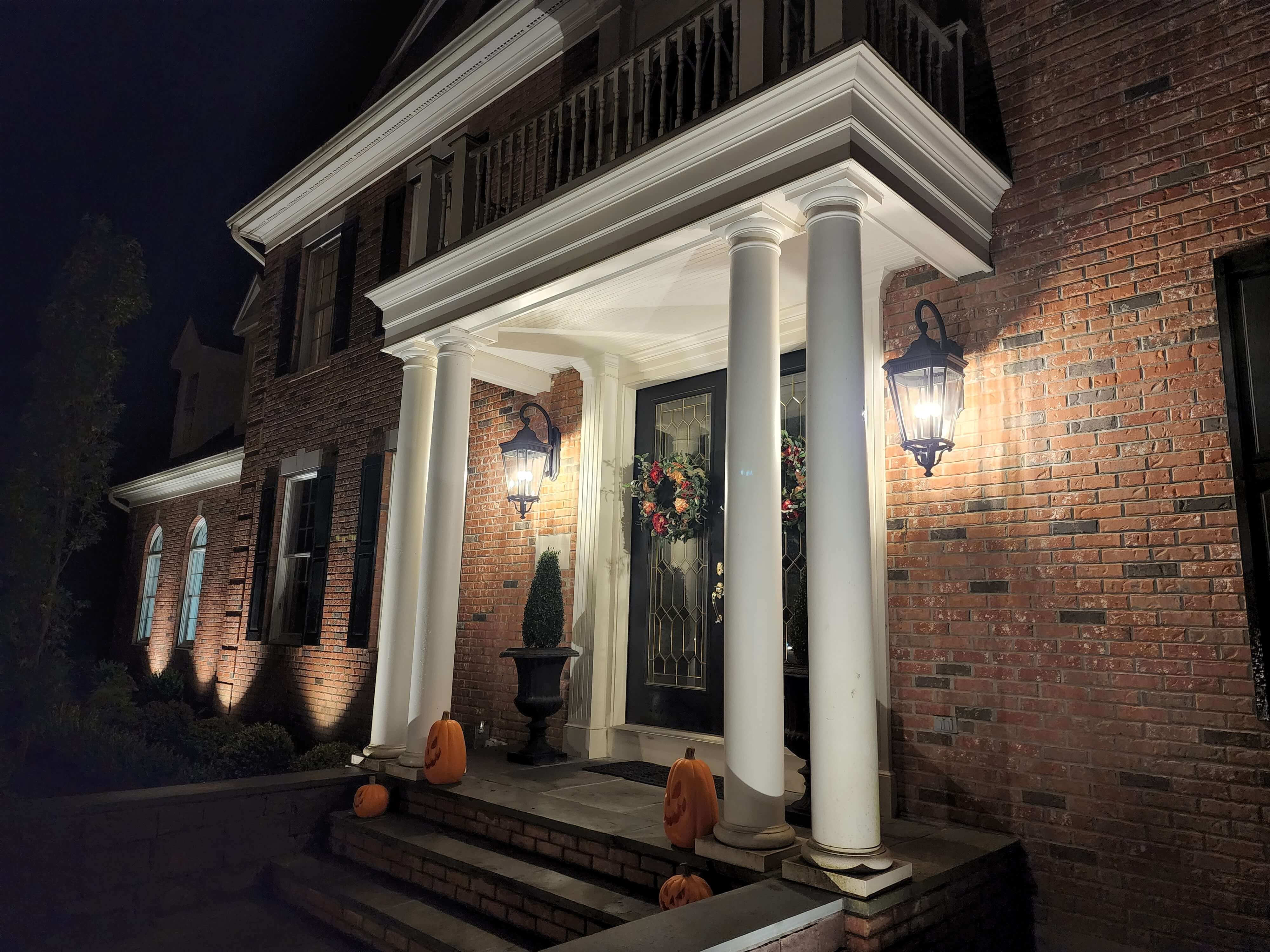 Colonial portico with decorative lantern sconces