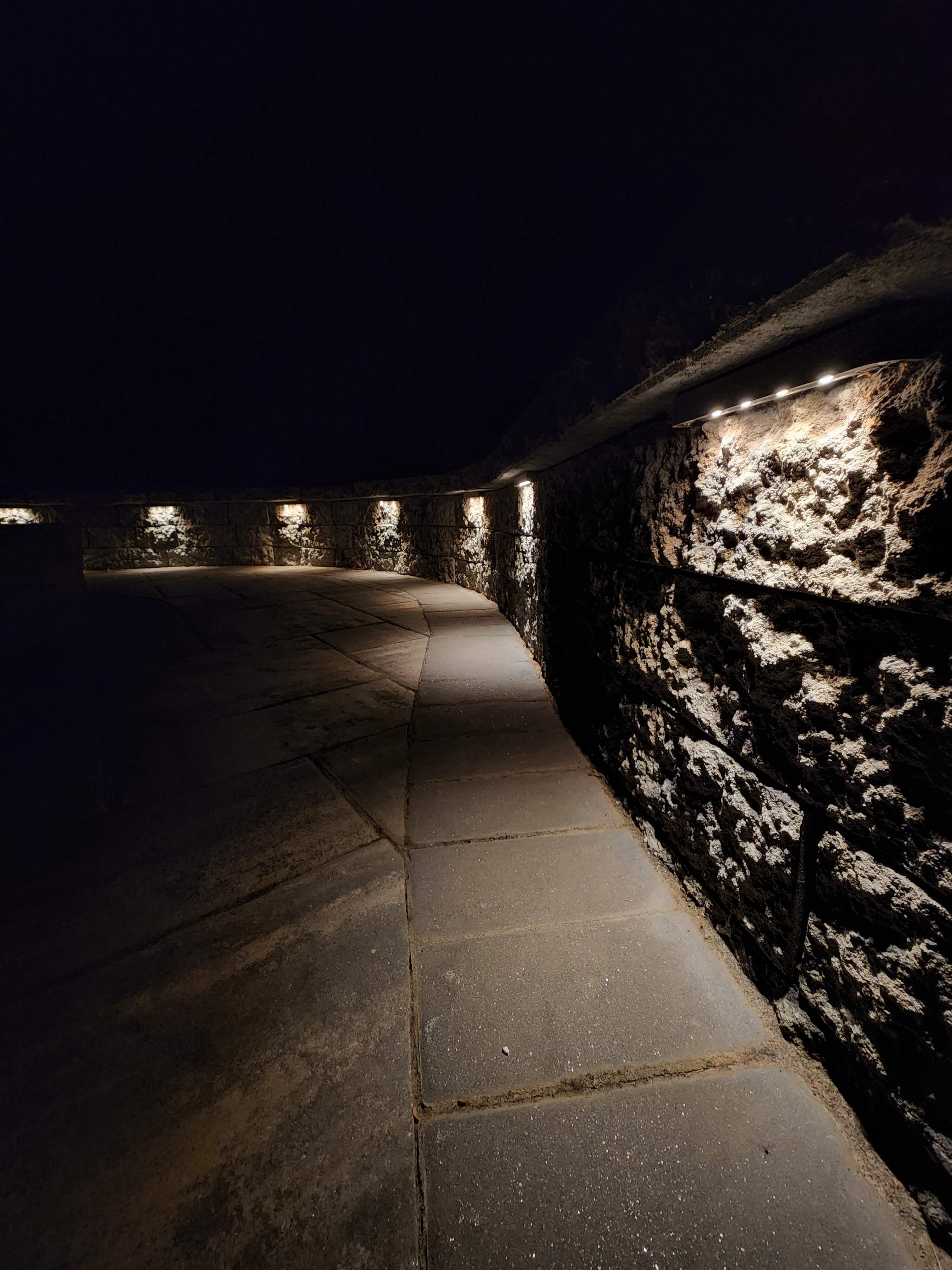 LED cap lights integrated into stone retaining wall