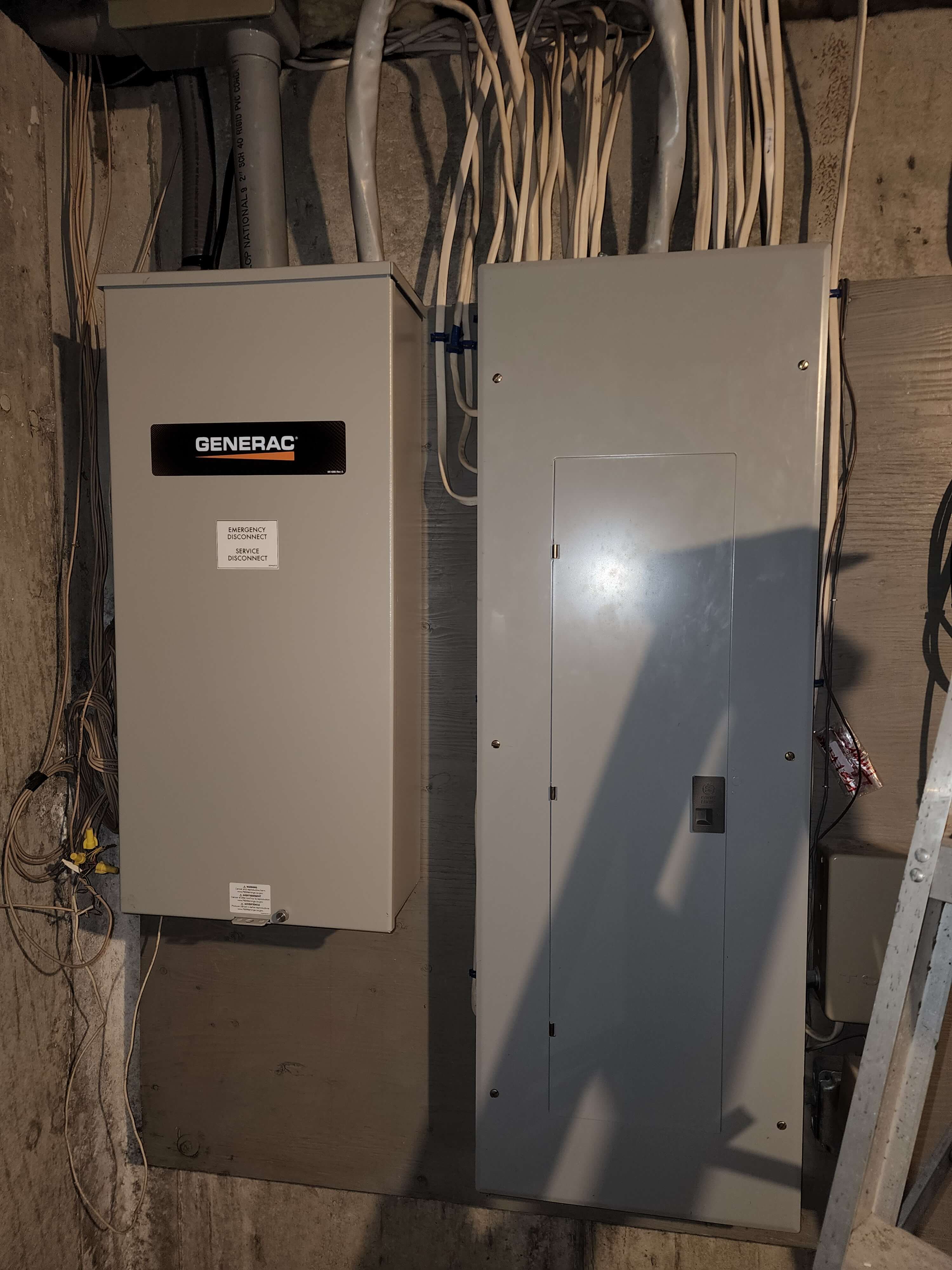 Generac automatic transfer switch next to main panel in basement